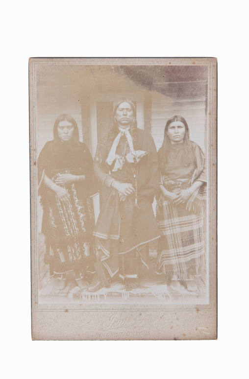 Comanche Chief Quanah Parker standing with two of his six wives, Topay and Chonie, Chickasha, Indian Territory